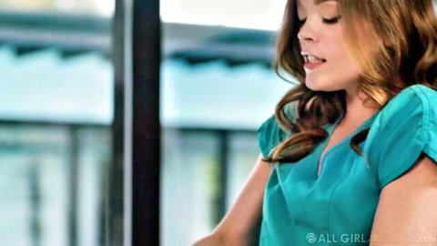 Blonde Katie Kush in teal scrubs top, smiling close-up