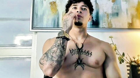 Tattooed muscular Latino Jasson Rodriguez shirtless, smoking seductively