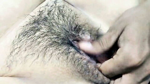 Dark hand spreading open hairy South Asian pussy revealing pink wet labia