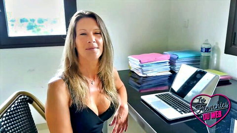 Milena sexy MILF in black dress with deep cleavage, smiling seductively
