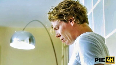 Ebo Black, blonde curly-haired man in white t-shirt, pensive pose in PIE4K video