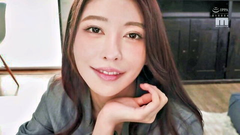 Elegant Asian woman with long dark hair smiling seductively in gray top