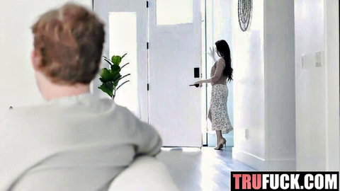 Alison Rey in white skirt teases at doorway, Jimmy Michaels watches from couch