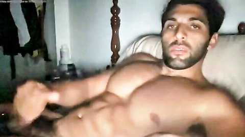 Muscular Middle Eastern hunk flexing ripped abs and chest shirtless