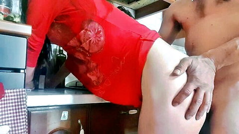 Brunette amateur in red dress bent over kitchen counter getting pussy fucked doggystyle by naked man
