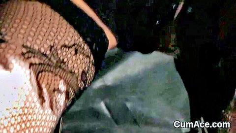 Closeup of woman's shaved pussy mound in fishnet stockings with thick cum dripping on white fabric