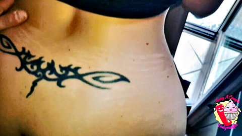 Pregnant brunette MILF exposing underboob and tribal tattoo on swollen belly