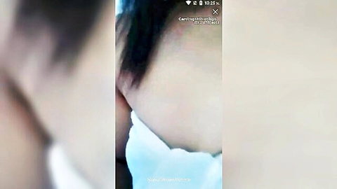 Blurry closeup of sexy Asian woman's neck and shoulder wrapped in white towel teasing