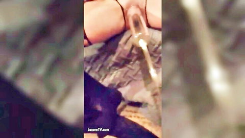 Woman in black lingerie with dildo penetrating pussy, clit choking close-up