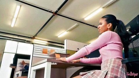 Ameena Green in pink sweater and plaid skirt, sensual office pose