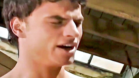 Young athletic man with short brown hair talks intensely in close-up safe sex video