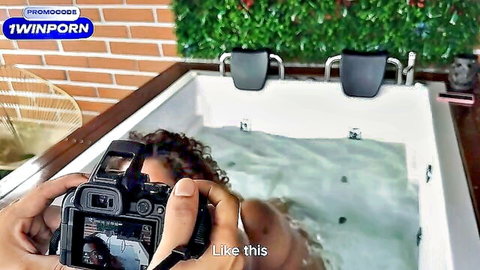 Ebony MILF with big tits poses wet in jacuzzi for photographer