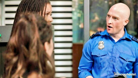 Bald cop in blue uniform talks to sexy black braided babe and brunette in police station