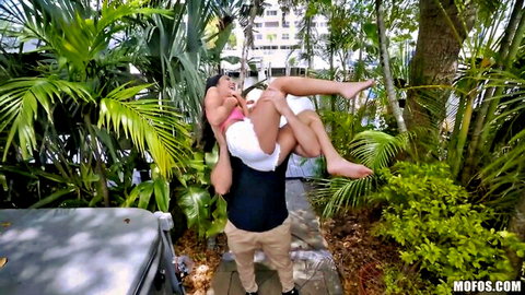 Slim Asian teen carried on man's shoulders in sexy outdoor pose