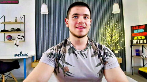 Handsome young gay model Cameron Cole smiling in leaf-patterned shirt