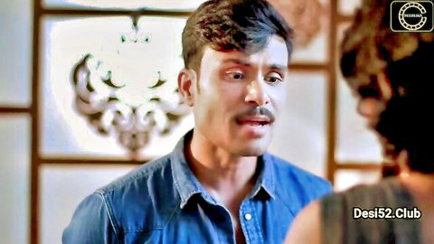 Mustached Indian man in denim shirt stares wide-eyed at another guy in tense Desi episode confrontation