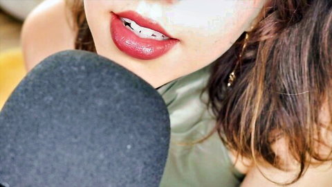 Princess Violette close-up with red lips, braces, and microphone in ASMR
