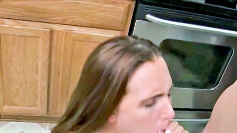 Brunette sucking thick cock in kitchen blowjob near oven cabinets