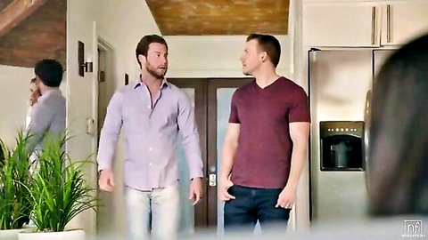 Two handsome clothed men standing and talking in modern kitchen hallway