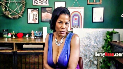 Ebony mature with massive tits in deep blue cleavage dress