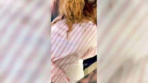Blurry blonde woman in pink striped top bent over with man behind her in doggystyle pose