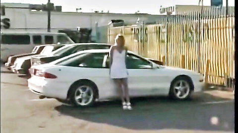 Blonde all-natural babe in short white dress poses by car before anal ride