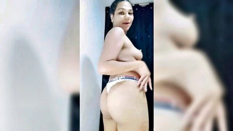 Curvy Latina doing teasing striptease in bathroom, topless reveal