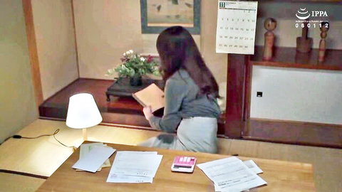 Elegant Japanese woman in sweater reading book in dim light