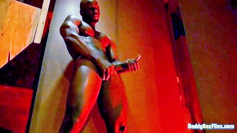 Muscular ebony man strokes his big cock in intense warehouse scene