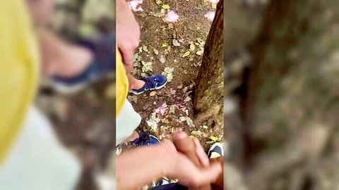 Gay men touching feet in blue sneakers on forest ground outdoor amateur