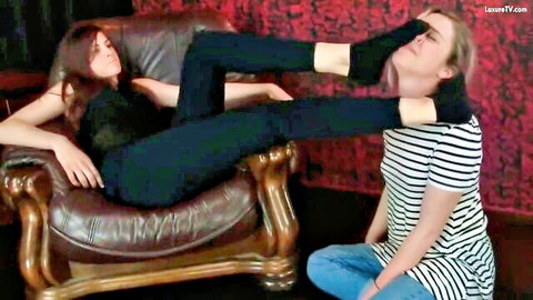 Redhead in leggings tramples blonde's face in lezdom foot fetish scene