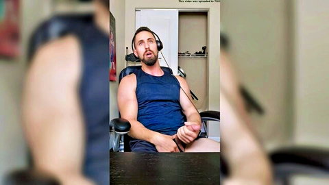 Bearded muscular man in tank top masturbating solo