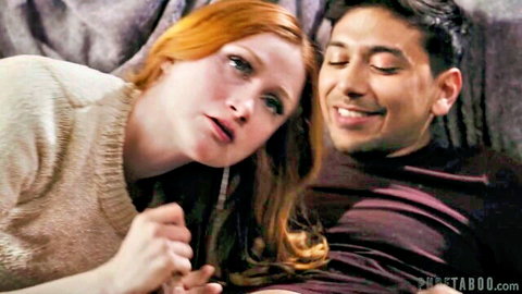 Redheaded Scarlet Skies gazes intimately at Max Fills on sofa