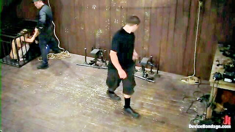 Amber Rayne bound in cage by Rain DeGrey and Ariel X in Kink BDSM scene