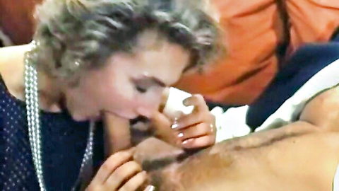 Mature silver-haired woman giving blowjob in classic scene