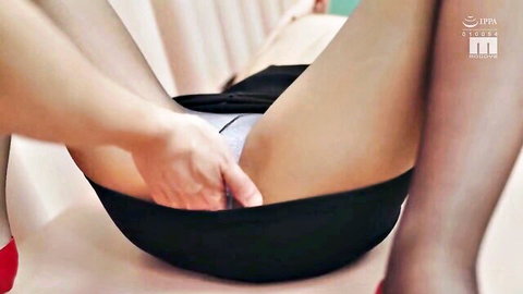 Asian JAV babe in black skirt pulls aside white panties, exposing wet pussy closeup