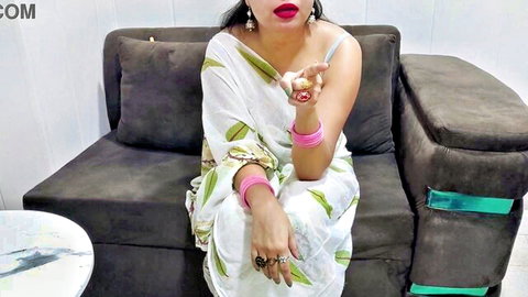 Curvy Indian woman in white saree with big breasts and red lips posing seductively