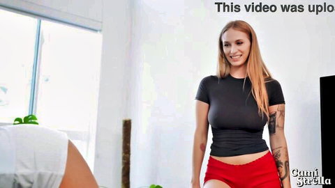 Cami Strella smiling in black crop top and red shorts