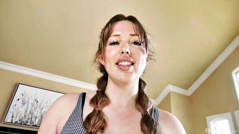 Ashley Red smiles seductively in pigtails and black tank top