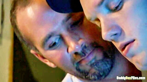 Mature daddy and young twink co-workers in close intimate face-to-face moment