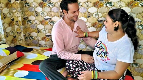 Desi chubby MILF in love t-shirt chats intimately with male friend on bed