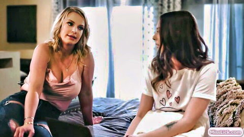 Blonde stepmom in pink top and jeans with brunette teen babe on bed