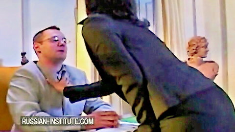 Curvy brunette in black dress seduces suited man at Russian Institute