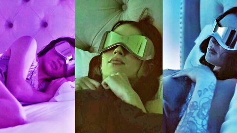 Seductive brunette in mirrored sleep mask lounging teasingly on bed