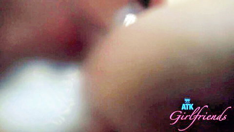 Blurry closeup of young woman's perky bare tits and pink nipples exposed