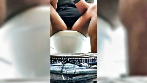 Man on toilet with pants down, farting and pooping fetish closeup