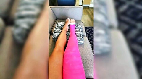 Sexy woman's bare legs with hot pink cast on one thigh spreading wide on couch