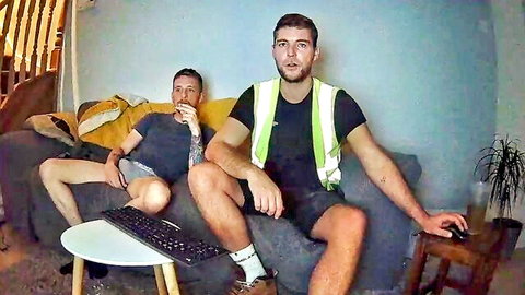 Muscular DILF in hi-vis vest and tattooed buddy tease bulging cocks in shorts on webcam couch