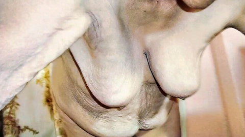Mature Latina granny showing sagging natural breasts close-up