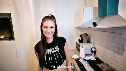 Amateur blonde in tight shiny GIRLS crop top smiling teasingly in modern kitchen